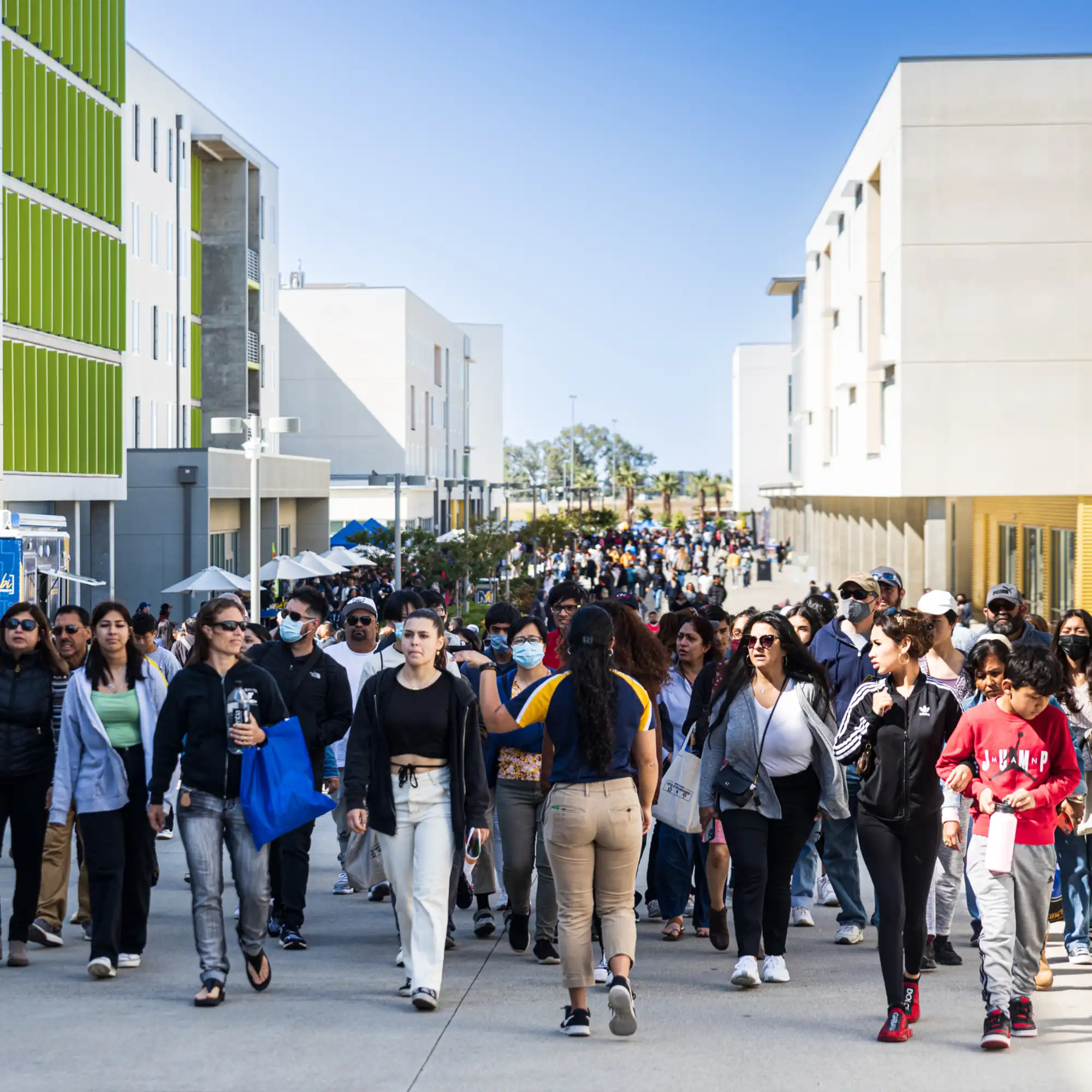 The academic walk crowded with booths and families during Bobcat Day.