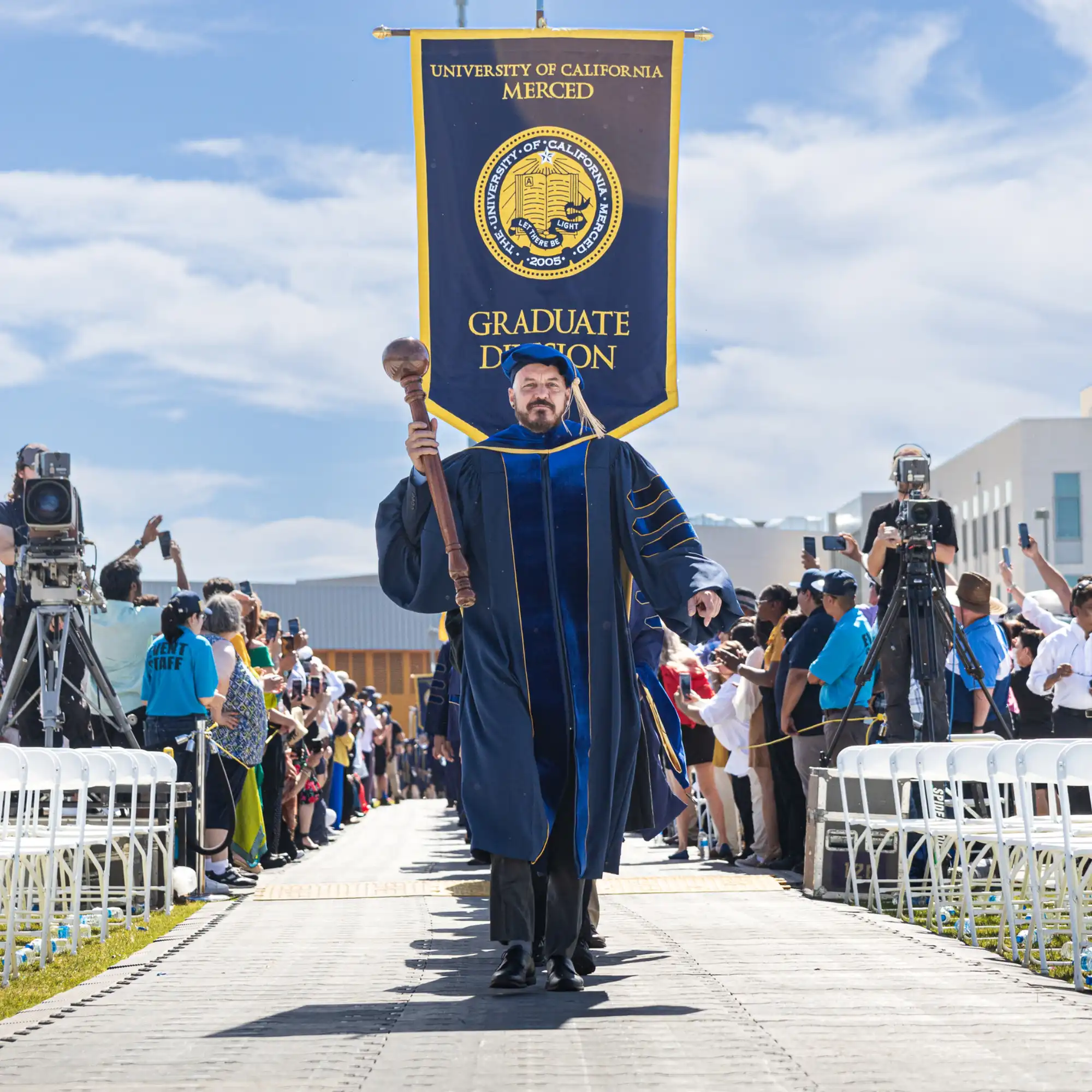 UC Merced’s Provost leading the official party to the commencement ceremony stage.