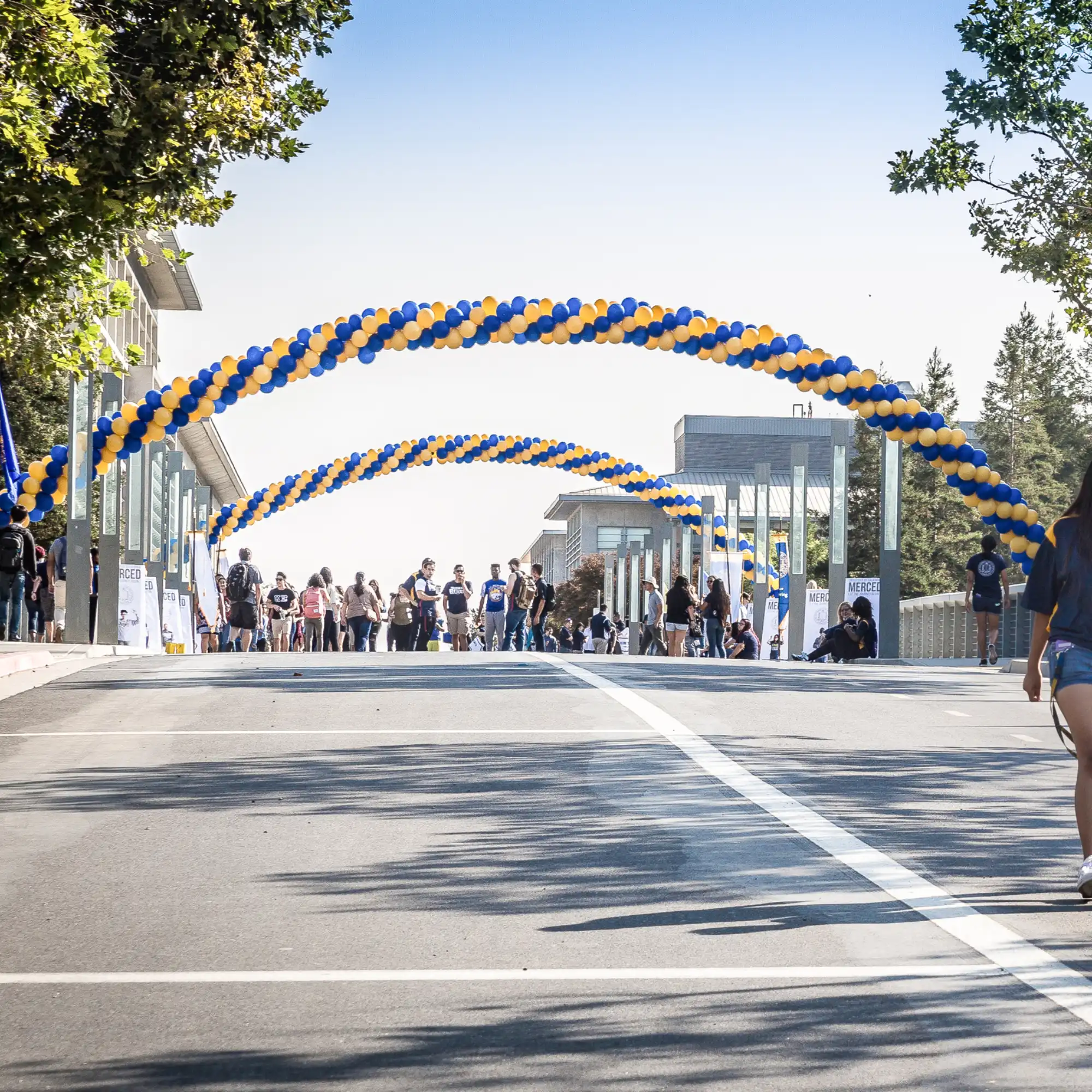 Scholar’s Bridge with balloon arches and students walking across during the first week of classes.